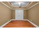 Empty bedroom with hardwood floors, recessed ceiling, and double doors to a closet at 9889 Between The Grns, Villa Rica, GA 30180