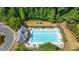 Aerial view of community pool, lounge chairs, playground, and bathhouse at 9889 Between The Grns, Villa Rica, GA 30180
