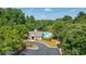 Enjoy the community pool with a bathhouse and lounge chairs surrounded by lush trees at 9889 Between The Grns, Villa Rica, GA 30180