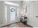 Bright entryway featuring a decorative glass door, side table and modern decor at 9889 Between The Grns, Villa Rica, GA 30180