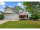 Beautiful home exterior with lush green lawn and mature trees at 9889 Between The Grns, Villa Rica, GA 30180