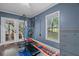 Bright home gym with large window, pull-up bar and weight rack, and French doors to outdoor space at 9889 Between The Grns, Villa Rica, GA 30180