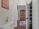 Hallway view with stylish decor, showcasing a glimpse of storage and an adjacent room at 9889 Between The Grns, Villa Rica, GA 30180