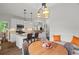 Eat-in kitchen featuring white cabinets, granite countertops, stainless appliances, island, and banquette seating area at 9889 Between The Grns, Villa Rica, GA 30180