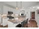 Well-lit kitchen featuring white cabinets, granite countertops, stainless steel appliances and kitchen island at 9889 Between The Grns, Villa Rica, GA 30180
