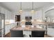 Spacious kitchen with white cabinets, granite countertops, stainless steel appliances, and kitchen island at 9889 Between The Grns, Villa Rica, GA 30180