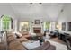 Bright living room featuring a fireplace, french doors and ample seating at 9889 Between The Grns, Villa Rica, GA 30180