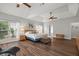 Spacious main bedroom boasts trey ceilings, abundant natural light, and warm wood floors at 9889 Between The Grns, Villa Rica, GA 30180