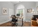 Inviting home office featuring a large window, modern desk, and neutral decor at 9889 Between The Grns, Villa Rica, GA 30180