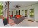 Inviting covered patio with stylish seating, ceiling fan, and access to the home through elegant French doors at 9889 Between The Grns, Villa Rica, GA 30180