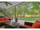 Relaxing covered patio overlooking the lush backyard, featuring comfortable seating and easy access to the deck at 9889 Between The Grns, Villa Rica, GA 30180