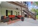 Comfortable covered patio with outdoor seating, ceiling fan, and convenient staircase to the upper deck at 9889 Between The Grns, Villa Rica, GA 30180