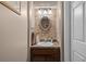 Stylish powder room with stone accent wall and updated fixtures and granite countertop at 9889 Between The Grns, Villa Rica, GA 30180