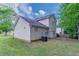 Exterior view of the back of the home with a grassy backyard at 2319 Rambling Way, Lithonia, GA 30058