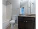 A full bathroom with a shower/tub, toilet, vanity and framed mirror at 2319 Rambling Way, Lithonia, GA 30058