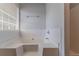 Bright bathroom featuring a white tiled tub and window with blinds at 2319 Rambling Way, Lithonia, GA 30058