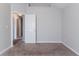 An empty bedroom with neutral walls, carpeted floors, and a door to the hallway at 2319 Rambling Way, Lithonia, GA 30058
