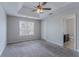 Spacious bedroom with a ceiling fan, carpet and large window with blinds at 2319 Rambling Way, Lithonia, GA 30058