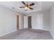 Spacious bedroom with a ceiling fan and multiple doors and closets at 2319 Rambling Way, Lithonia, GA 30058