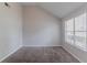 Cozy bedroom with neutral paint, carpet, and a large window with natural light at 2319 Rambling Way, Lithonia, GA 30058