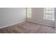 Carpeted bedroom featuring two windows with natural light and neutral paint at 2319 Rambling Way, Lithonia, GA 30058