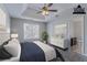 Staged bedroom featuring a ceiling fan and large window with blinds at 2319 Rambling Way, Lithonia, GA 30058