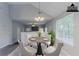 Bright dining area with a round table, four chairs, large window, and modern chandelier at 2319 Rambling Way, Lithonia, GA 30058
