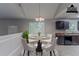 Bright dining area with a round table, four chairs, and a modern chandelier at 2319 Rambling Way, Lithonia, GA 30058