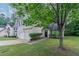 Two-story home with a well-manicured lawn, front shrubbery, and a two-car garage at 2319 Rambling Way, Lithonia, GA 30058