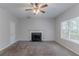 Spacious living room with a fireplace, carpet, a ceiling fan and lots of natural light at 2319 Rambling Way, Lithonia, GA 30058