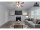 Staged living room with a fireplace, a large sofa, wall art and lots of natural light at 2319 Rambling Way, Lithonia, GA 30058