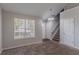 Bright living room with neutral paint, plush carpet, and natural light from the window at 2319 Rambling Way, Lithonia, GA 30058