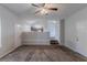 Spacious living room with neutral paint, carpet, ceiling fan, and staircase to another level at 2319 Rambling Way, Lithonia, GA 30058