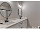 This bathroom showcases a white double sink vanity and modern lighting for a clean, bright aesthetic at 5299 Noble Village Way, Lilburn, GA 30047