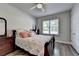 This bedroom features warm wood floors, a ceiling fan, and a restful atmosphere at 5299 Noble Village Way, Lilburn, GA 30047