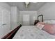 Comfortable bedroom with neutral tones, a ceiling fan and a view to the entry door at 5299 Noble Village Way, Lilburn, GA 30047