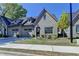 Charming single Gathering home with a two-car garage and professionally landscaped front yard at 5299 Noble Village Way, Lilburn, GA 30047