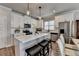 Modern kitchen with a center island, white cabinets, stainless steel appliances, and breakfast bar at 5299 Noble Village Way, Lilburn, GA 30047