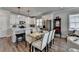 Modern kitchen with white cabinets, stainless steel appliances, and a dining area at 5299 Noble Village Way, Lilburn, GA 30047