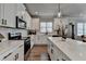 Modern kitchen with white cabinets, a subway tile backsplash and stainless steel appliances at 5299 Noble Village Way, Lilburn, GA 30047