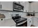 Close-up of a kitchen featuring stainless steel appliances and white subway tile at 5299 Noble Village Way, Lilburn, GA 30047