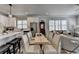 Bright kitchen and dining area with white cabinets, stainless steel appliances, and modern lighting at 5299 Noble Village Way, Lilburn, GA 30047