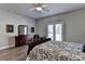Bright main bedroom with wood floors, classic furniture, and a view of the outdoors at 5299 Noble Village Way, Lilburn, GA 30047