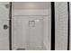 The walk-in shower features subway tile, a bench, and a sleek black frame for a modern and luxurious experience at 5299 Noble Village Way, Lilburn, GA 30047
