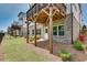 Backyard featuring well-maintained lawn, exterior view of the house, and some landscaping at 208 Idylwilde Way, Canton, GA 30115