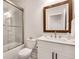 Beautiful bathroom with a glass shower, a white vanity with a decorative mirror and modern fixtures at 208 Idylwilde Way, Canton, GA 30115