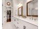 Bathroom features double vanity, framed mirrors, and a walk-in closet in view at 208 Idylwilde Way, Canton, GA 30115