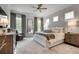 Inviting bedroom with neutral tones, a ceiling fan, and large windows providing plenty of natural light at 208 Idylwilde Way, Canton, GA 30115
