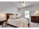 Cozy bedroom featuring a ceiling fan, a window, a wooden bed, side tables and warm-toned decor at 208 Idylwilde Way, Canton, GA 30115
