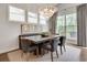 Formal dining area featuring a modern chandelier, ample windows, and comfortable seating for Gathering meals at 208 Idylwilde Way, Canton, GA 30115